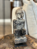 Gelukspopje hurkend van hout