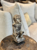 Gelukspopje hurkend van hout