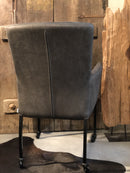 Eetkamerstoel Oscar in antraciet leercombinatie met skatewieltjes